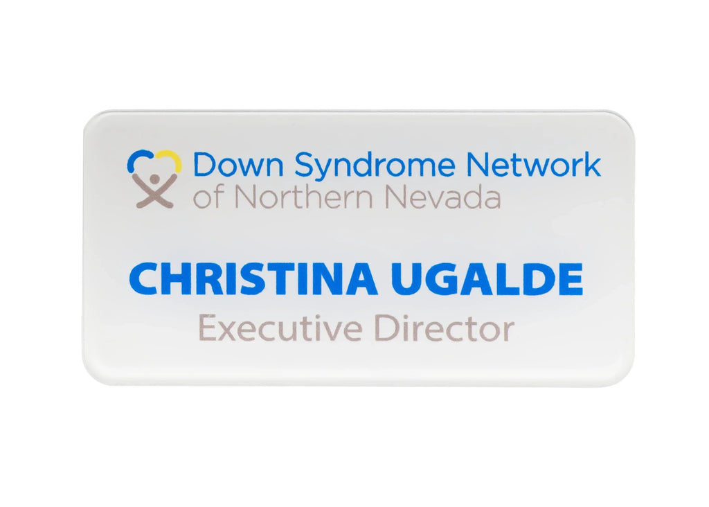 A rectangular white nameplate with rounded corners, featuring the Down Syndrome Network of Northern Nevada logo in blue and gray lettering.
