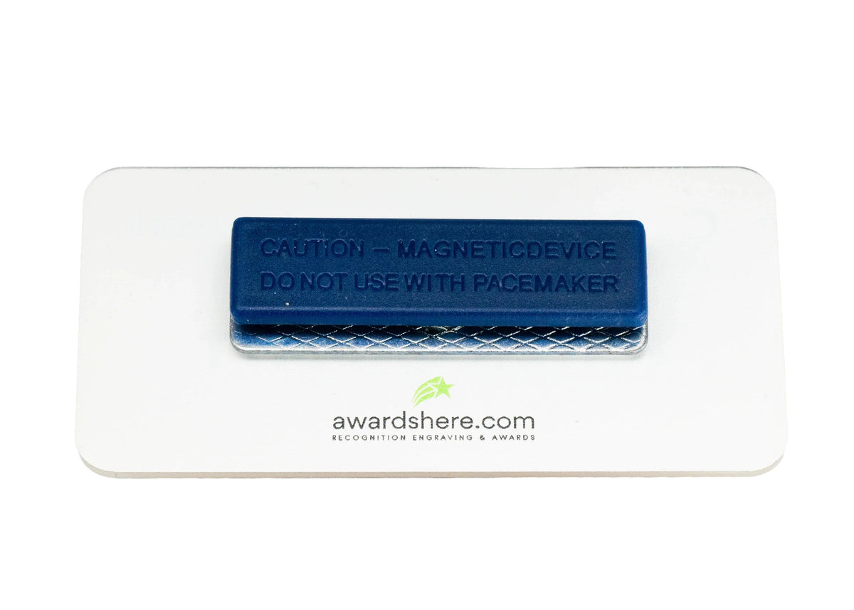 Rectangular magnetic strip on the back of a name badge with text and awardshere.com branding on a white background