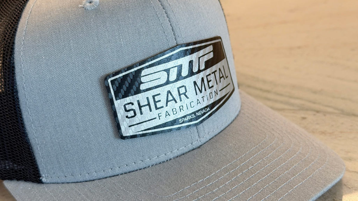 Grey trucker hat with a 'Shear Metal Fabrication' logo patch