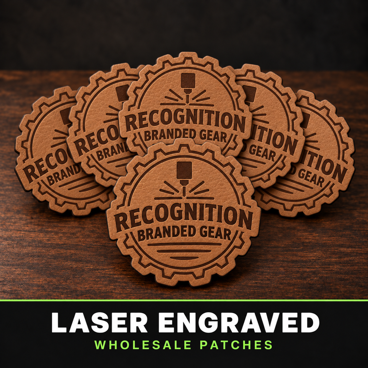 Five laser-engraved brown leather patches with a gear badge design reading 'Recognition Branded Gear,' arranged on a dark wood surface. A black banner at the bottom reads 'LASER ENGRAVED WHOLESALE PATCHES.
